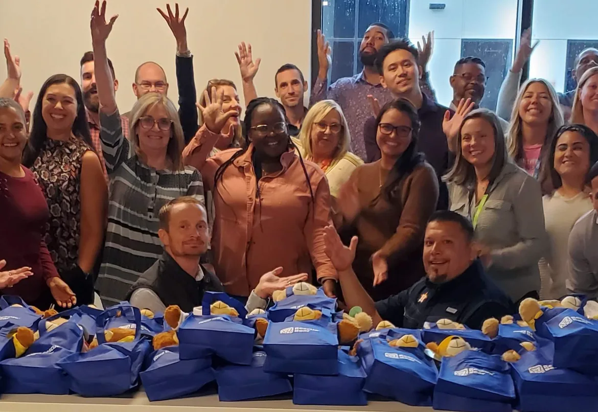 Coworkers creating stuffed bears for children
